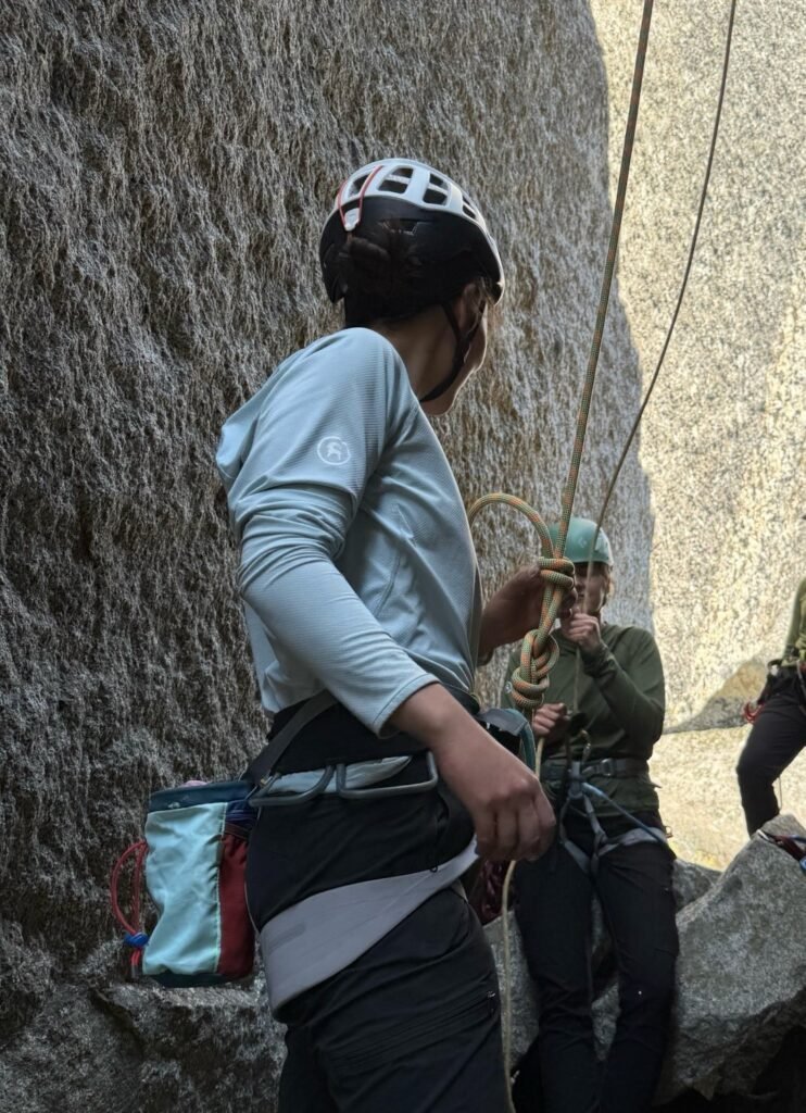 Two rock climbers looking at each other on the ground
