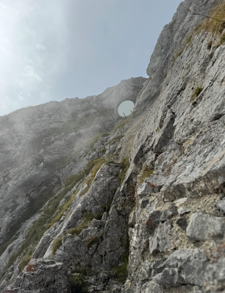 A view up a steep rocky cliff.